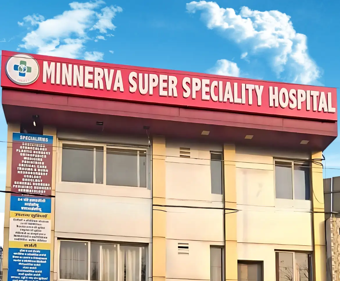 Minerva Super Speciality Hospital building exterior with red signage and blue sky