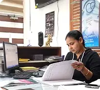 Clinic staff helping with booking assistance and transport arrangements